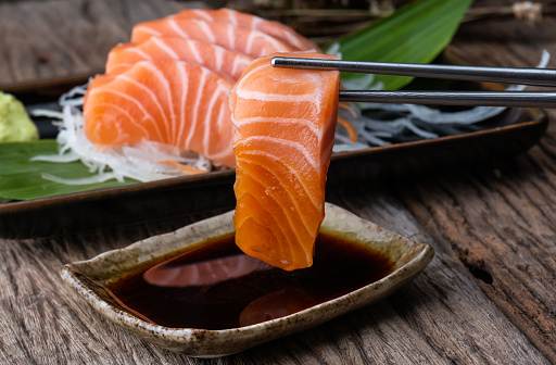 Salmon sashimi fresh and raw salmon fish slice ready to serve with shoyu sauce  in Japanese food style.
